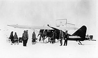 Wop May loads his airplane at Aklavik.