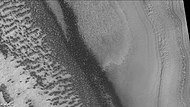 Reynolds crater showing layers and dark spots from defrosting, as seen by CTX camera (on Mars Reconnaissance Orbiter). Area is covered by frost, when the frost disappears the underlying dark ground is exposed. Layers are also visible. Note: this is an enlargement of a previous image of Reynolds crater.