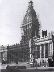 B&W photograph of a scaffolding-covered Town Hall undergoing cleaning