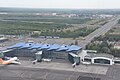 An aerial view of NQZ International Terminal 1 in July 2021 including the Astana Light Metro visible in the background