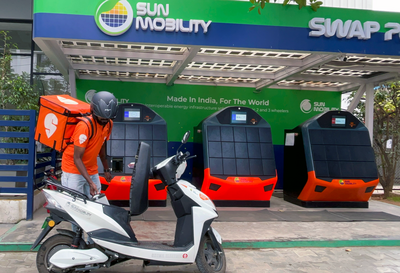 A Swiggy delivery partner swapping the battery of his electric scooter