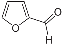 Skeleton formula of a ring of four carbons and one oxygen, with a carbon-oxygen attached to a carbon next to an oxygen