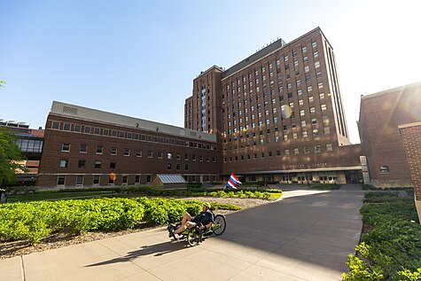 Mayo Memorial Building at sunrise with biker in the foreground