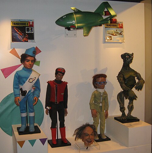 Replica puppets of Scott Tracy from Thunderbirds (left) and Captain Scarlet, showing the different body proportions of the two generations