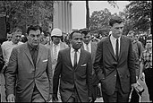 James Meredith (center) being escorted to class after the riot