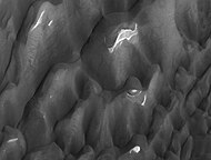 Lyot crater dunes, as seen by HiRISE. Click on image to see light toned deposits and dust devil tracks.