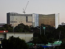 This is a photograph of two neighbouring buildings, each belonging to the University of South Australia and the University of Adelaide respectively.