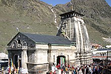 Large white building, with people around it for scale