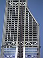 A skyscraper under construction in Shanghai, showing truss sections for mechanical floors.