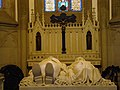 Tomb with effigies of Emperor Pedro II of Brazil and his wife Teresa Cristina in front of an altar crucifix in the Cathedral of Petrópolis, Brazil. The cross is made of black granite from Tijuca forest.[39]