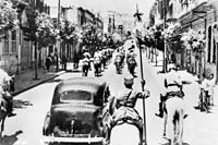 The fall of Damascus to the Allies, late June 1941. A car carrying the Free French commanders,General Georges Catroux and Major-General Paul Louis Le Gentilhomme, enters the city. They are escorted by Vichy French Circassian cavalry (Gardes Tcherkess).