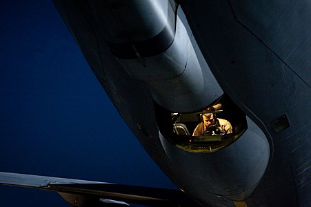 A boom operator in a USAF KC-135 conducts a preflight inspection in the boom pod prior to a mission in the Middle East.