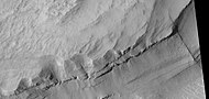 Close view of layers, as seen by HiRISE under HiWish program. A ridge cuts across the layers at a right angle.