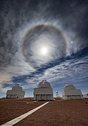 Three telescopes stand sentry under an unusual skyscape in this image from Cerro Tololo Inter-American Observatory (CTIO)[50]