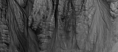 Gully aprons as seen by HiRISE under HiWish program This image was named HiRISE Picture of the Day for June 25, 2024.