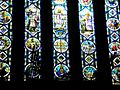 Facing west, silhouette of the organ against stained glass panels in balcony