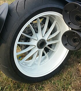 White rear wheel of a Ducati Diavel mounted to a single sided swingarm