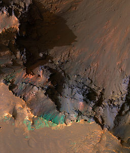 South rim of Coprates Chasma, image is about a kilometer wide. With enhanced IR colors, we see a portion of the very top of the south wall of the canyon, looking down onto the steep upper slopes of the canyon.