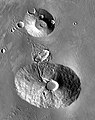 2001 Mars Odyssey THEMIS mosaic of Ceraunius Tholus (lower volcano) and Uranius Tholus (upper volcano). Ceraunius Tholus is about as high as Earth's Mount Everest.