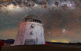 The dark cloud-like structures are dusty areas of the Milky Way that absorb visible light