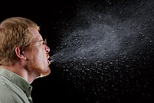 Cough/sneeze droplets visualized in dark background using Tyndall scattering