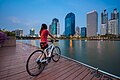 A woman with a bicycle at Benchakitti Park in Bangkok