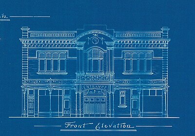 a dark blue background white line drawing of the front facade of a two story picture theatre with quite a few decorative details. Underneath the drawing in fancy printed handwriting 'Front Elevation'