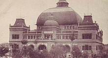 A black and white photo of a large domed building