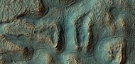 Close, color view of crater ejecta, as seen by HiRISE under HiWish program. Benches around mounds my mark a former water level. The hot ejecta may have melted ice in the ground forming small channels.