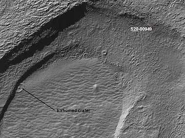 Crater that was buried in another age and is now being exposed by erosion, as seen by the Mars Global Surveyor, under the MOC Public Targeting Program