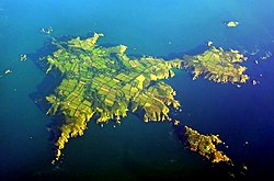 Aerial view of Sark; North is to the left, Little Sark in the upper right and Brecqhou below it.