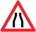 Road narrows on both sides