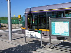 A tram waits to depart at Sandyford