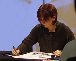 Yuu Watase illustrating a sample of Ayashi no Ceres at Lucca Comics 2004 in Italy