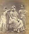 Image 1A Tamil Hindu girl (center) in 1870 wearing a half-saree, flowers and jewelry from her Ritu Kala samskara rite of passage (from Samskara (rite of passage))