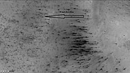 Dust trails in Main crater, as seen by CTX camera (on Mars Reconnaissance Orbiter). Arrow indicates wind direction. In the spring, as the temperature rises, dry ice turns into a pressurized gas, and then blows through a weak spot and carries with it dust. If there is a wind, the dust is deposited in an elongated form as in this image.