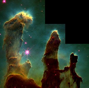 A Hubble photo of three gas pillars in the Eagle Nebula. Some squares in the upper-right of the image are black and contain nothing.