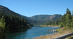 A river flows through forested hills.