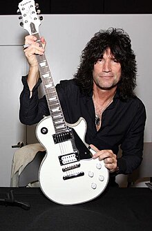 Thayer holding his White Lightning signature guitar