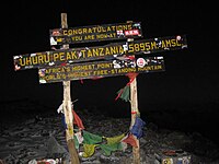 Sign at Uhuru peak, indicating to trekkers that they have reached the top