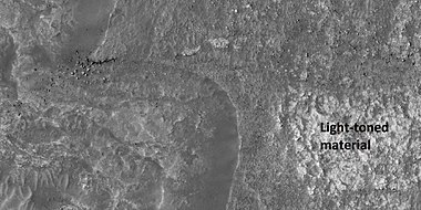 Close view of surface, showing boulders and light-toned material, as seen by HiRISE under HiWish program