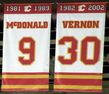 Two large white banners with red and yellow trim at the top and bottom. They read "McDONALD 9 1981–1989" and "VERNON 30 1982–2002" respectively