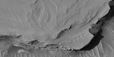 Close view of layers, as seen by HiRISE under HiWish program. At least one layer is light-toned which may indicated hydrated minerals.