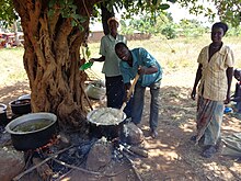 A man Mingles corn flour delicacy commonly referred to as Posho during a village children's party in Nsono Village, Namayingo District-Eastern Uganda