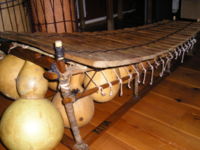 A fixed-key balafon, showing gourd resonators with membrane holes