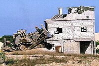 IDF Caterpillar D9L razing a Palestinian house