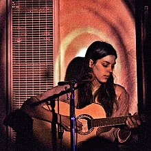 Byrne playing guitar