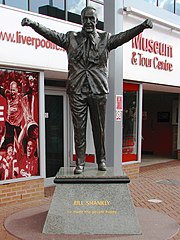 Statue of a man with his arms held aloft