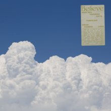 A dense layer of white clouds seen from above, with a clear blue sky behind it.