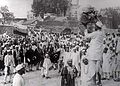 Hindus and Muslims, displaying the flags of both the Indian National Congress and the All-India Muslim League, collecting clothes to be later burnt as a part of the non-cooperation movement initiated by Gandhi.